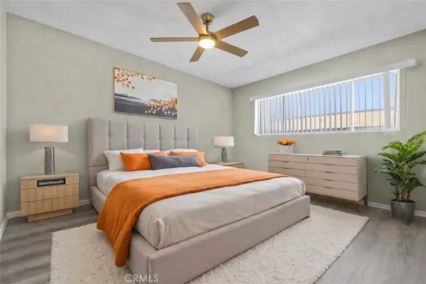 a bedroom with a large bed and a chandelier