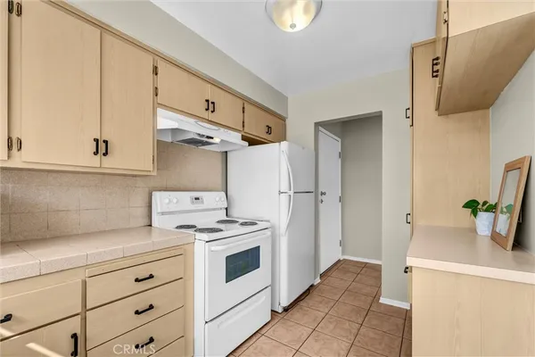 a kitchen with a stove a sink and a refrigerator