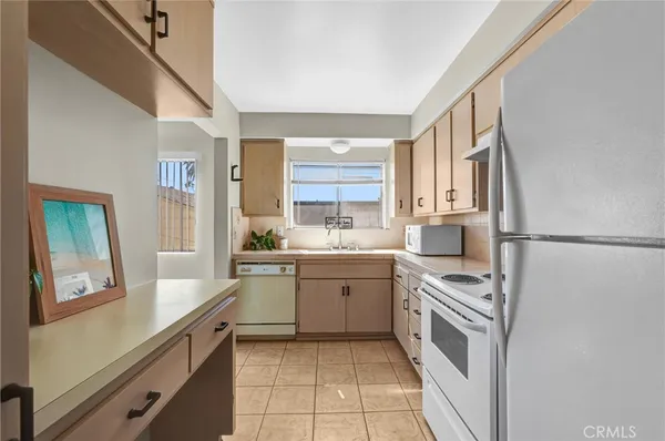 a kitchen with stainless steel appliances a sink cabinets and wooden floor