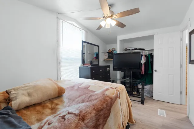 a bedroom with a bed and a flat screen tv