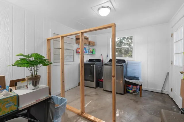a living room with furniture a potted plant and a table
