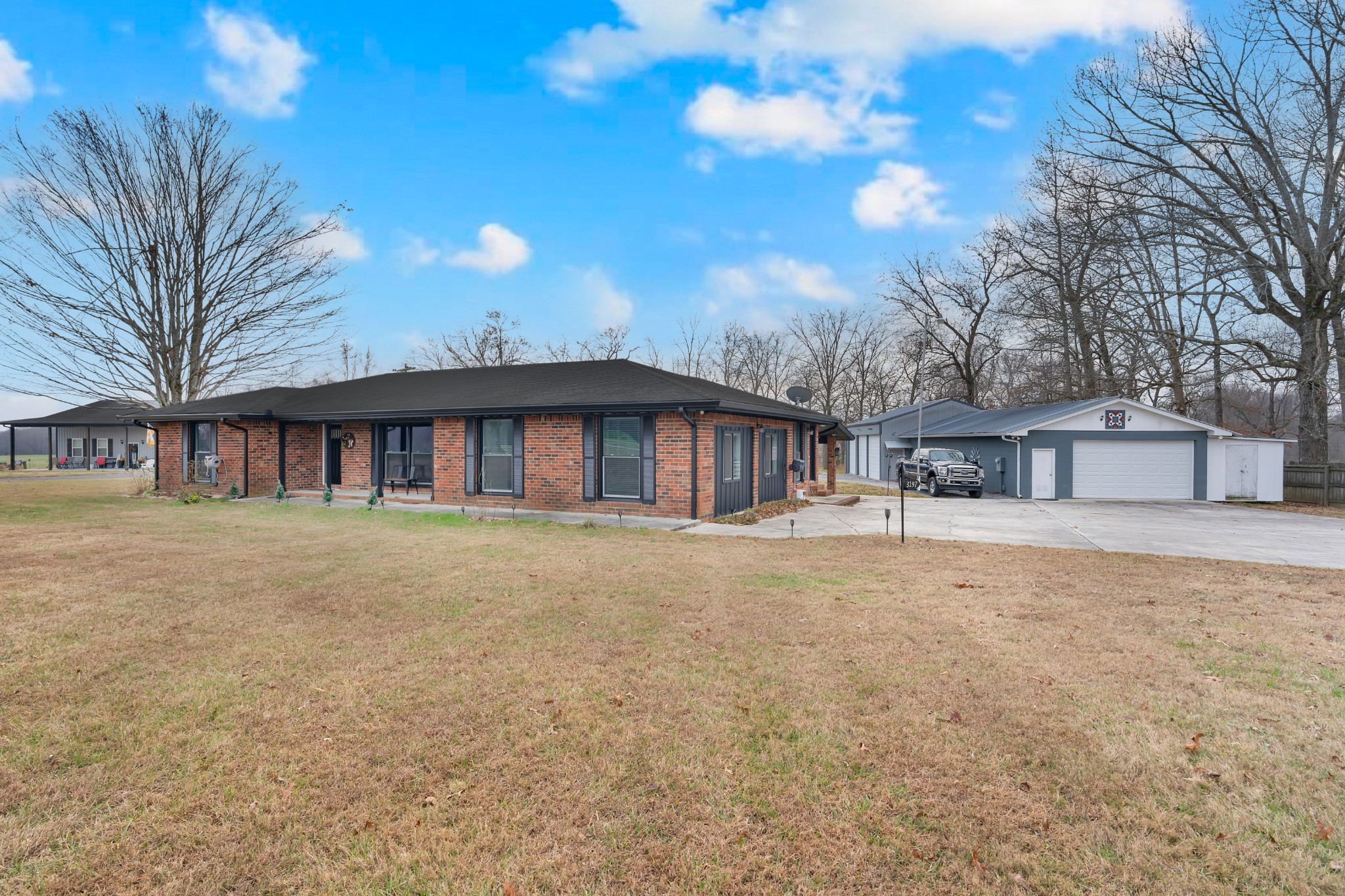 3197 Matts Hollow Road Manchester, TN 37355 - Photo 4 of 54 a view of a house with a yard and garage