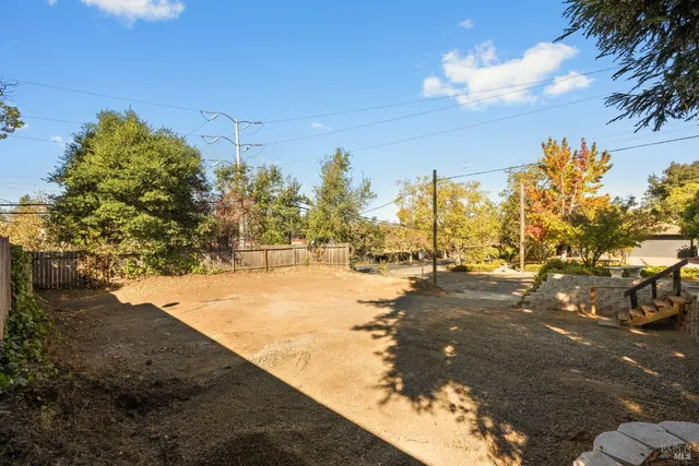 a view of road with large trees