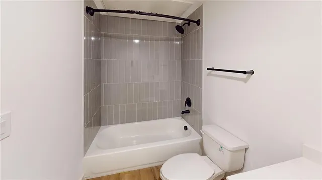 a bathroom with a toilet and a bathtub