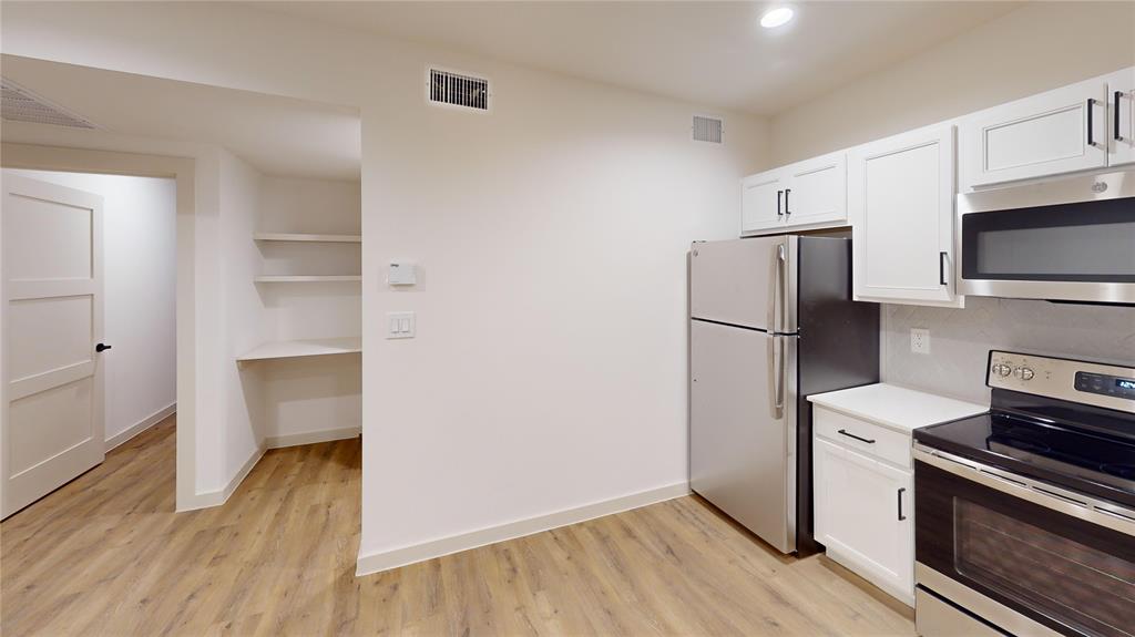 715 North Lancaster Avenue, Unit 210 Dallas, TX 75203 - Photo 14 of 22 a kitchen with a refrigerator and a stove top oven