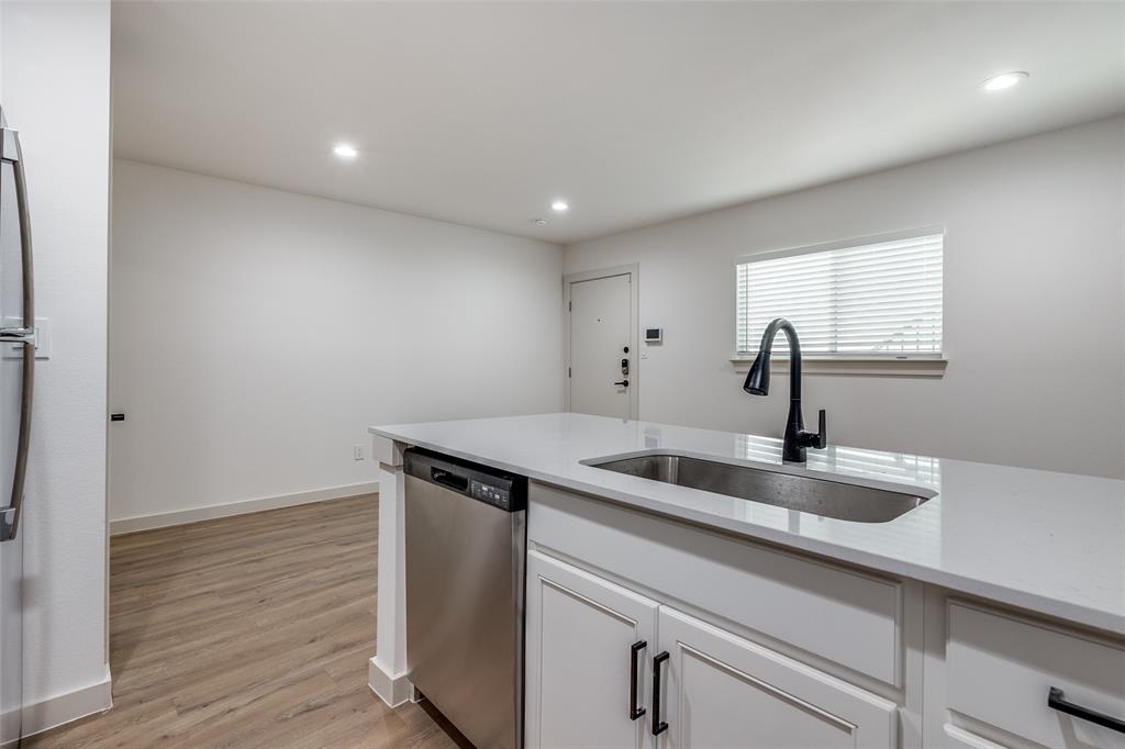 715 North Lancaster Avenue, Unit 210 Dallas, TX 75203 - Photo 22 of 22 a kitchen with a sink cabinets and wooden floor