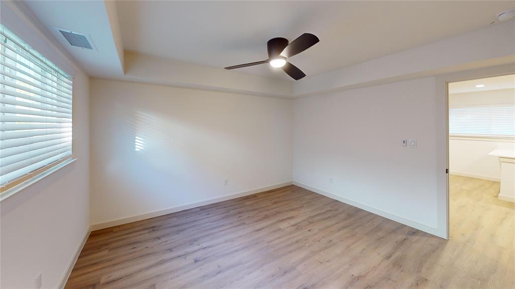 715 North Lancaster Avenue, Unit 210 Dallas, TX 75203 - Photo 3 of 22 an empty room with wooden floor fan and windows