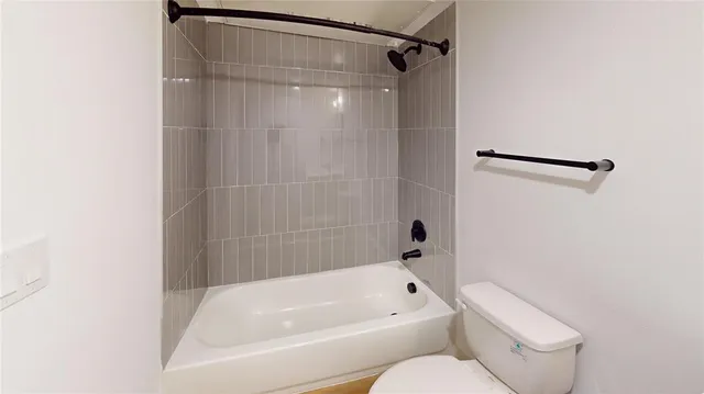 a bathroom with a toilet and a bathtub