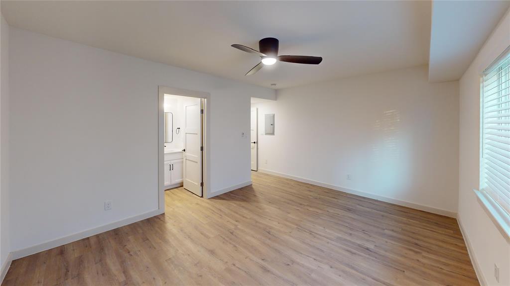 715 North Lancaster Avenue, Unit 210 Dallas, TX 75203 - Photo 8 of 22 an empty room with wooden floor and windows