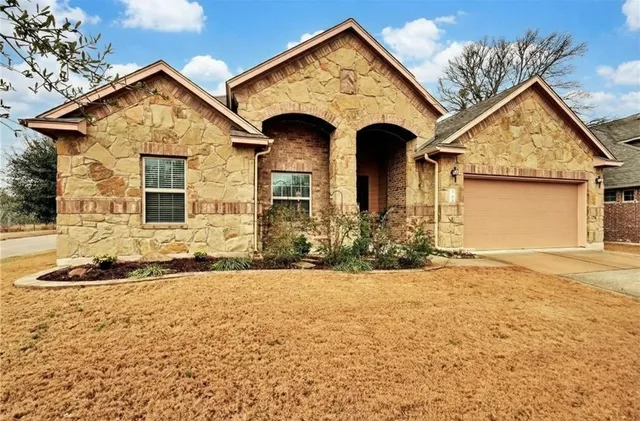 a front view of a house with a yard