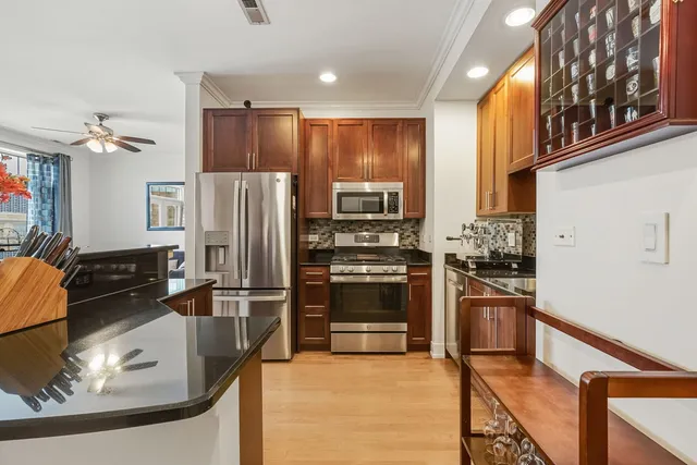 a kitchen with stainless steel appliances granite countertop a refrigerator stove and oven