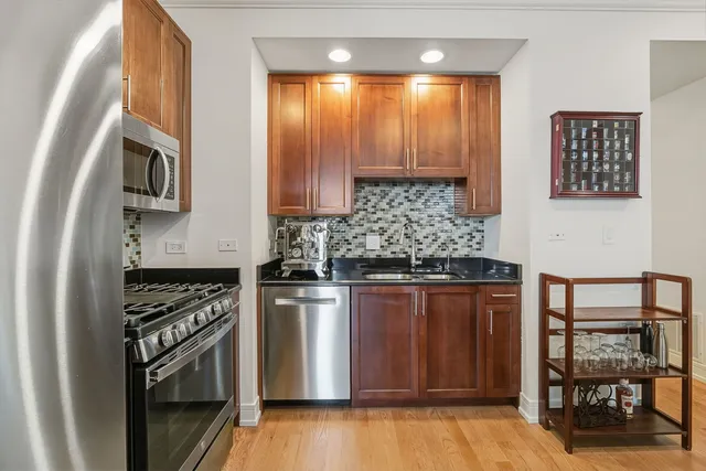a kitchen with stainless steel appliances granite countertop a stove and a refrigerator