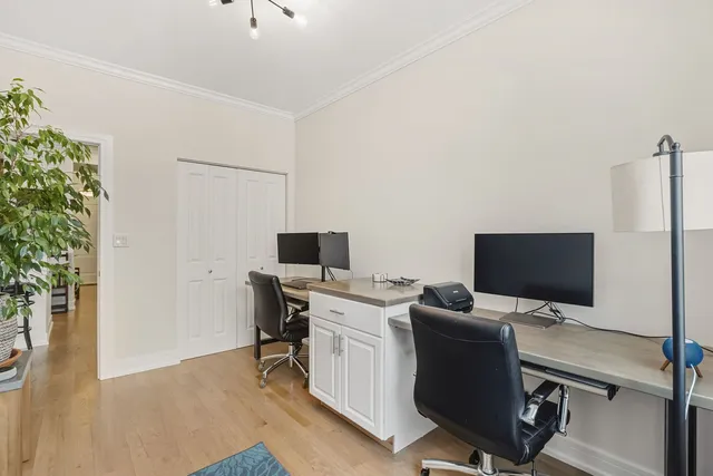 a view of a workspace with furniture and wooden floor
