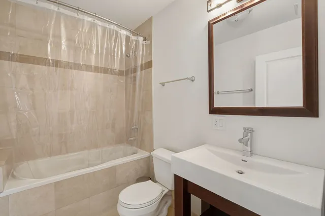 a bathroom with a sink a toilet and bathtub