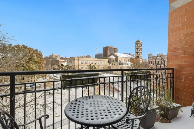 a view of a balcony with two chairs