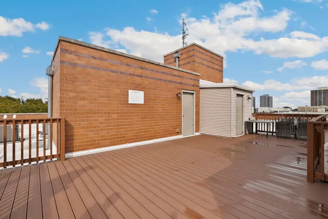 a view of house with deck and wooden floor