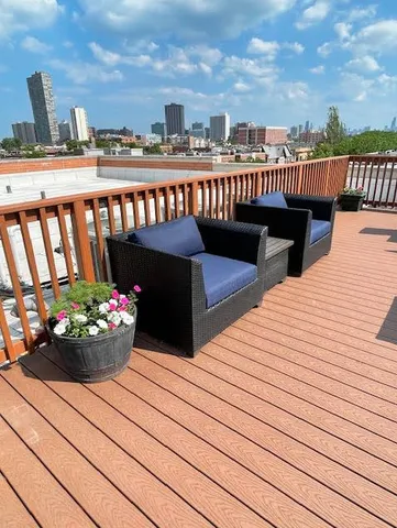 a view of a balcony with wooden benches