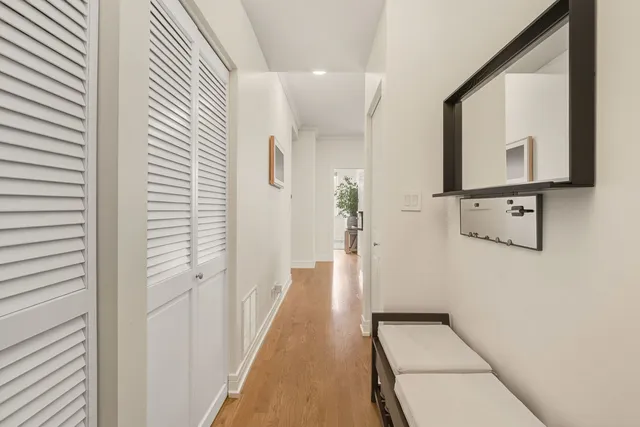 a view of a hallway with wooden floor