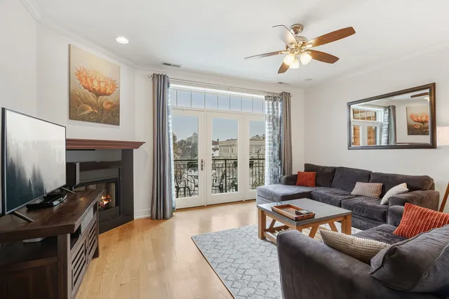 a living room with furniture a fireplace and a flat screen tv