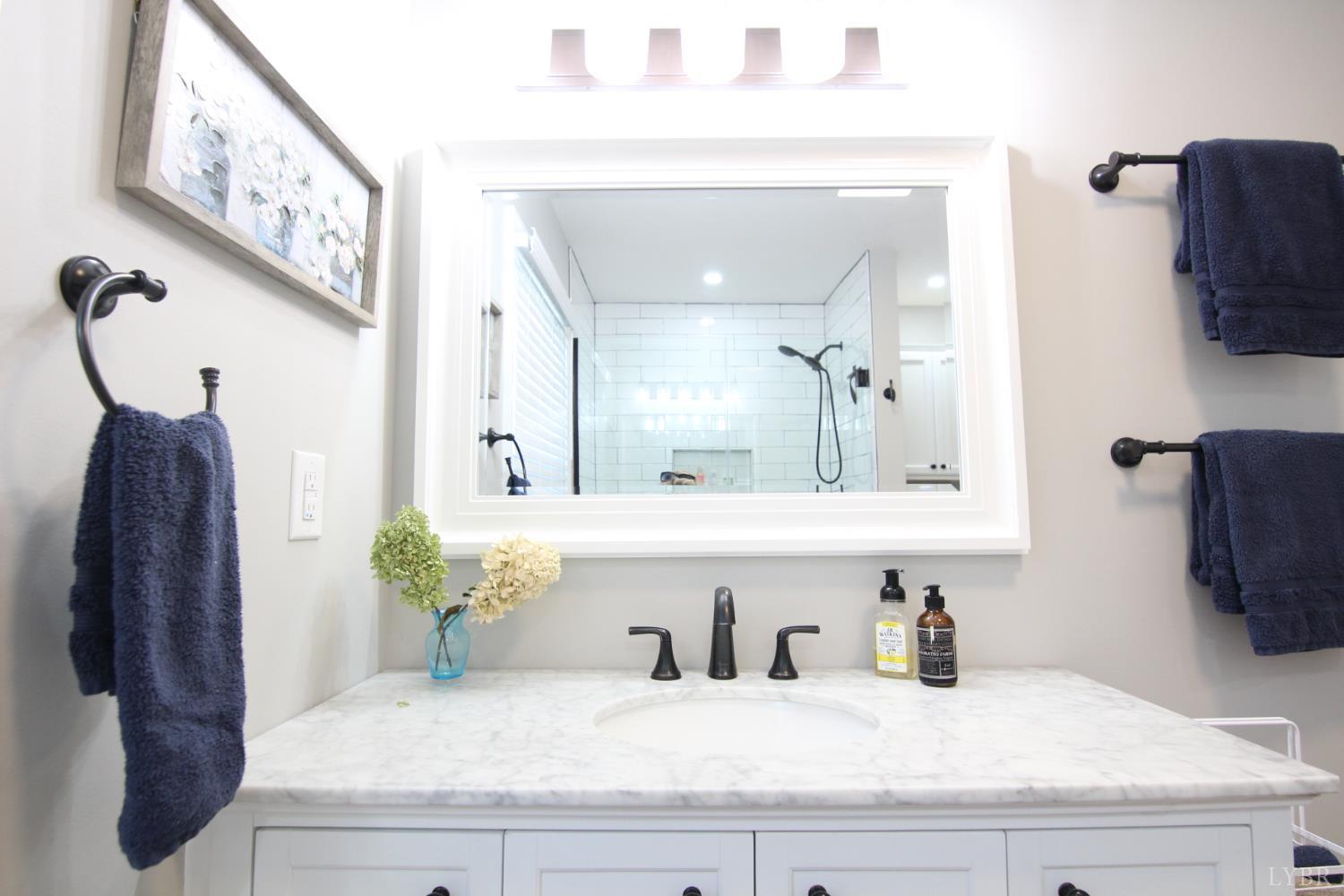 609 Midvale Street Lynchburg, VA 24502 - Photo 13 of 18 a bathroom with a sink and a mirror