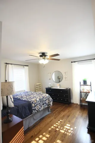 a view of a hallway view with wooden floor and furniture