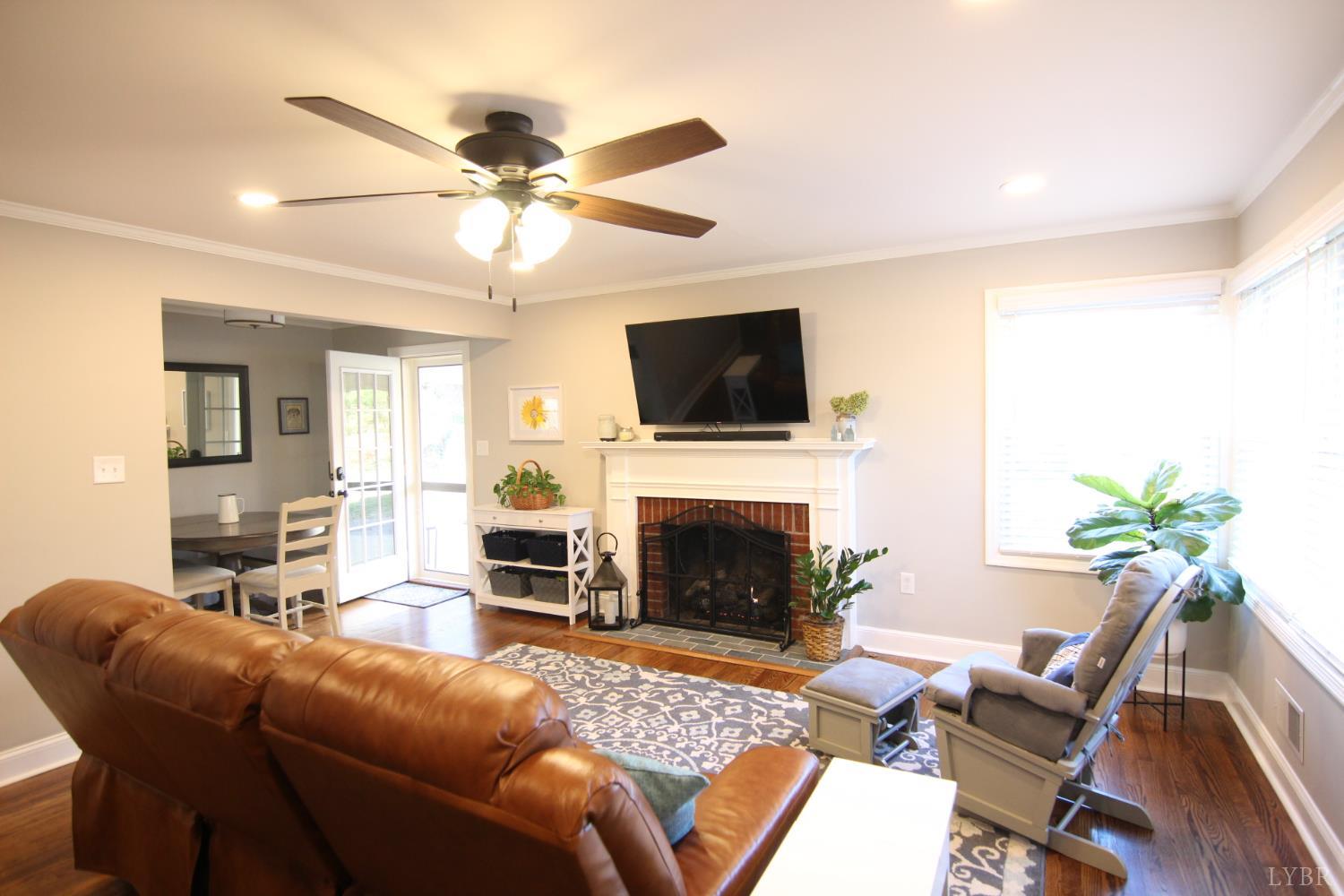 609 Midvale Street Lynchburg, VA 24502 - Photo 2 of 18 a living room with furniture a fireplace and a flat screen tv