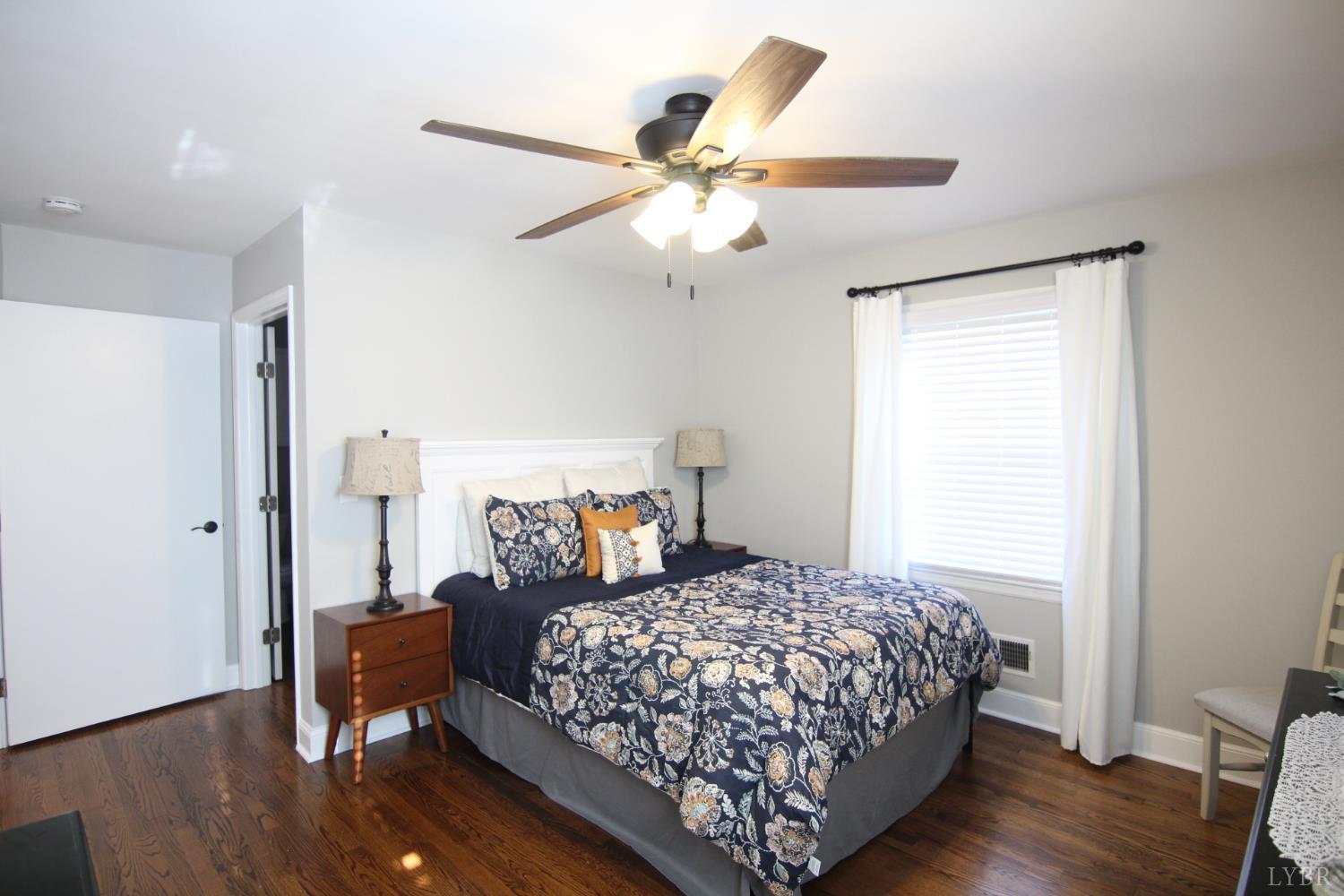 609 Midvale Street Lynchburg, VA 24502 - Photo 7 of 18 a bedroom with a bed and wooden floor