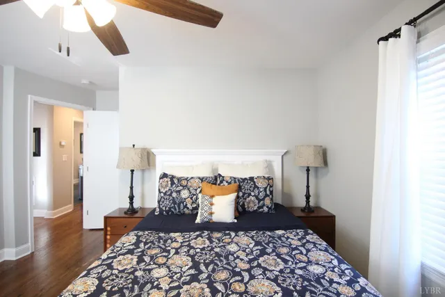 a bed room with furniture and a wooden floor