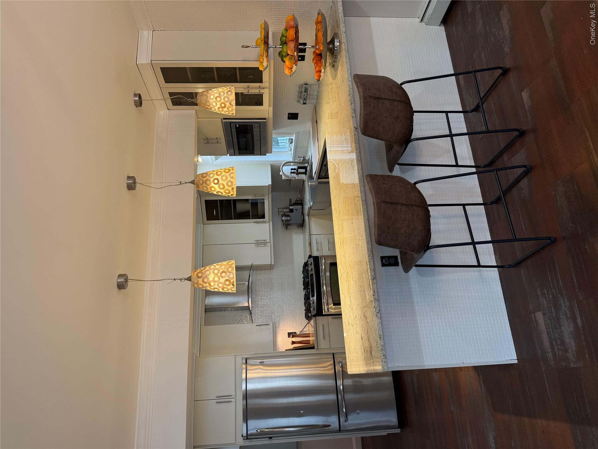 29 Wilton Road Rye Brook, NY 10573 - Photo 3 of 18 Kitchen with refrigerator, dark wood-style floors, a peninsula, range, and extractor fan