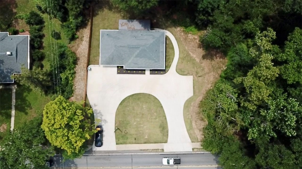 317 Pendleton Road Clemson, SC 29631 - Photo 2 of 36 An aerial perspective reveals a charming residence nestled amidst verdant landscaping with a sweeping driveway.