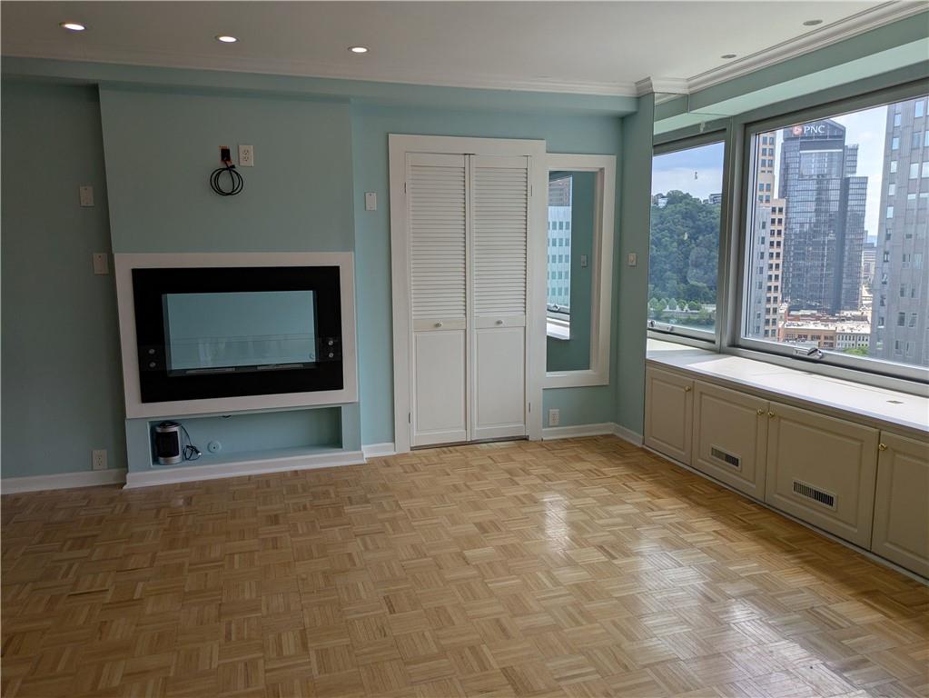 320 Fort Duquesne Boulevard, Unit 24M Pittsburgh, PA 15222 - Photo 27 of 40 a view of an empty room with a fireplace and a window