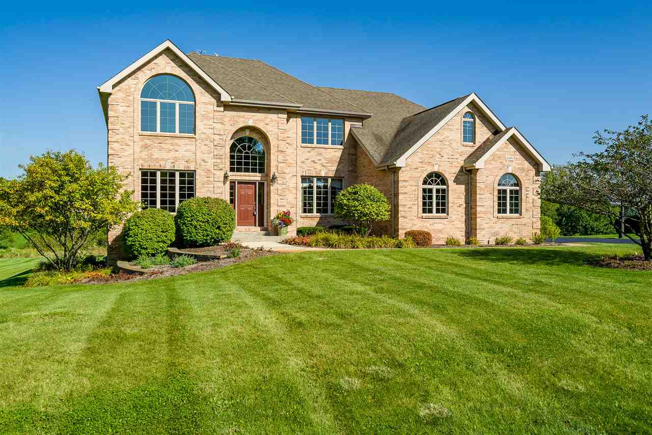 12495 Ashfield Road Caledonia, IL 61011 - Photo 1 of 25 a front view of a house with a yard and garage