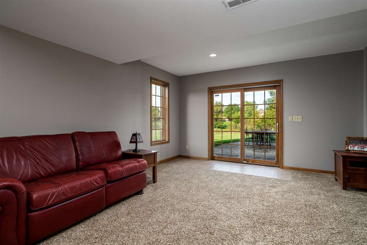 12495 Ashfield Road Caledonia, IL 61011 - Photo 23 of 25 a living room with furniture and a flat screen tv