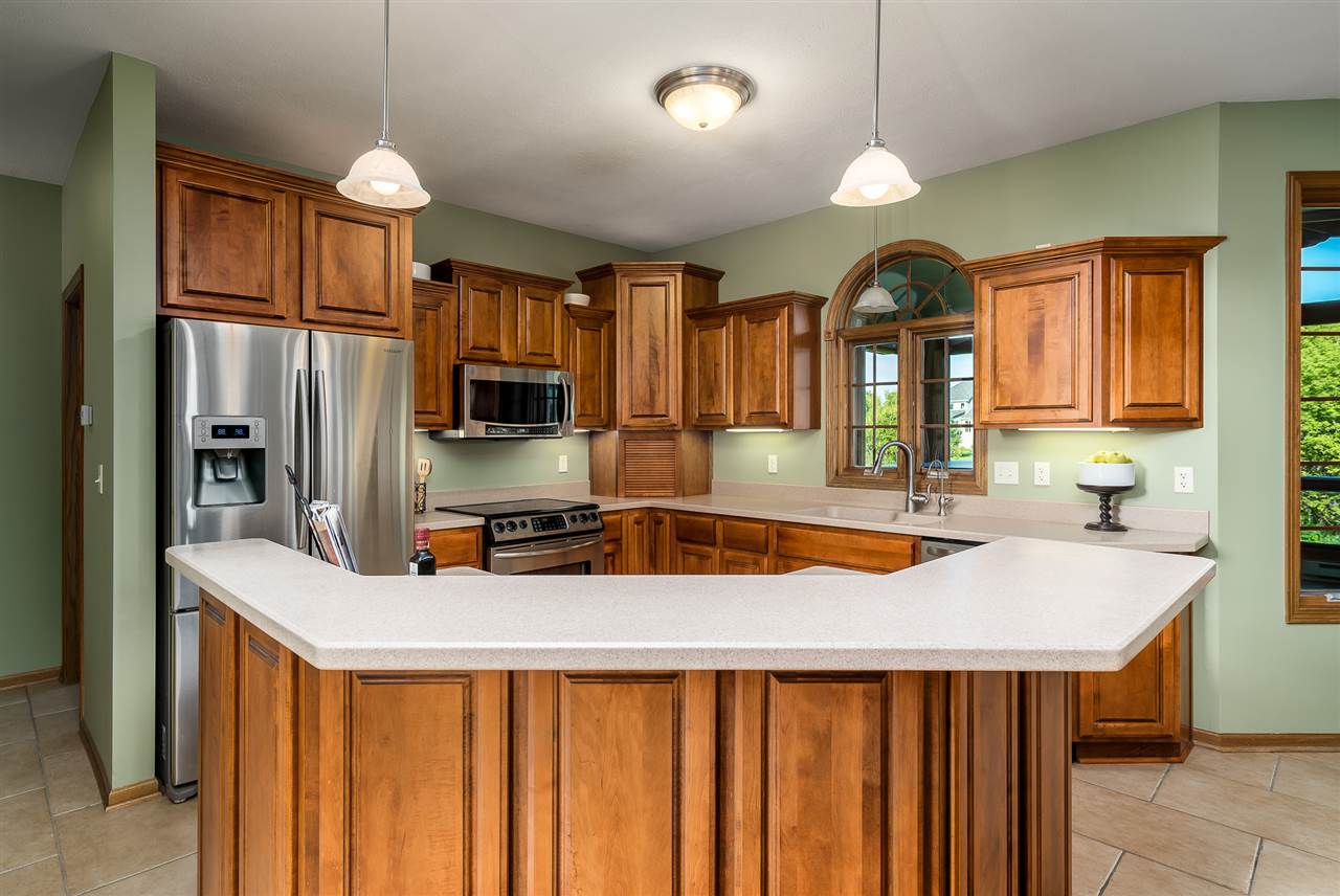 12495 Ashfield Road Caledonia, IL 61011 - Photo 7 of 25 a kitchen with stainless steel appliances a sink stove and refrigerator