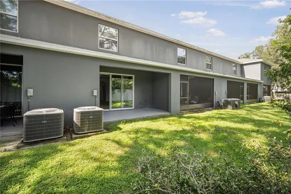 a view of a house with pool and sitting area