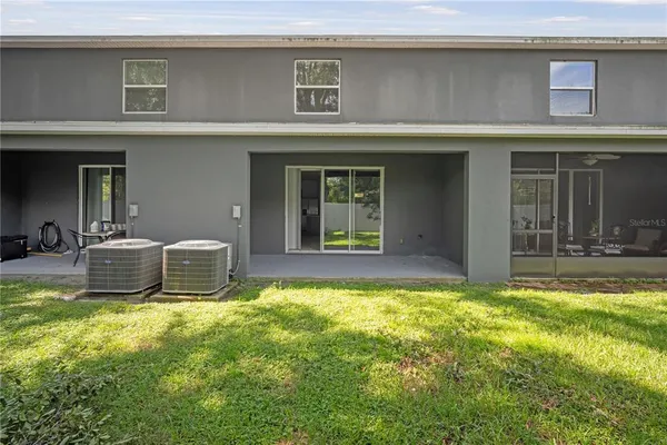 a view of a house with patio and a yard