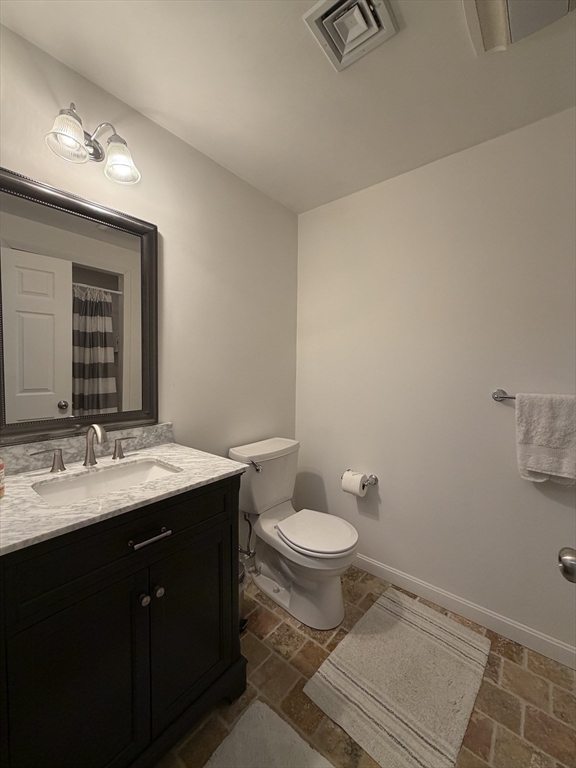 65 Denton Road Wellesley, MA 02482 - Photo 14 of 16 a bathroom with a granite countertop sink toilet and mirror