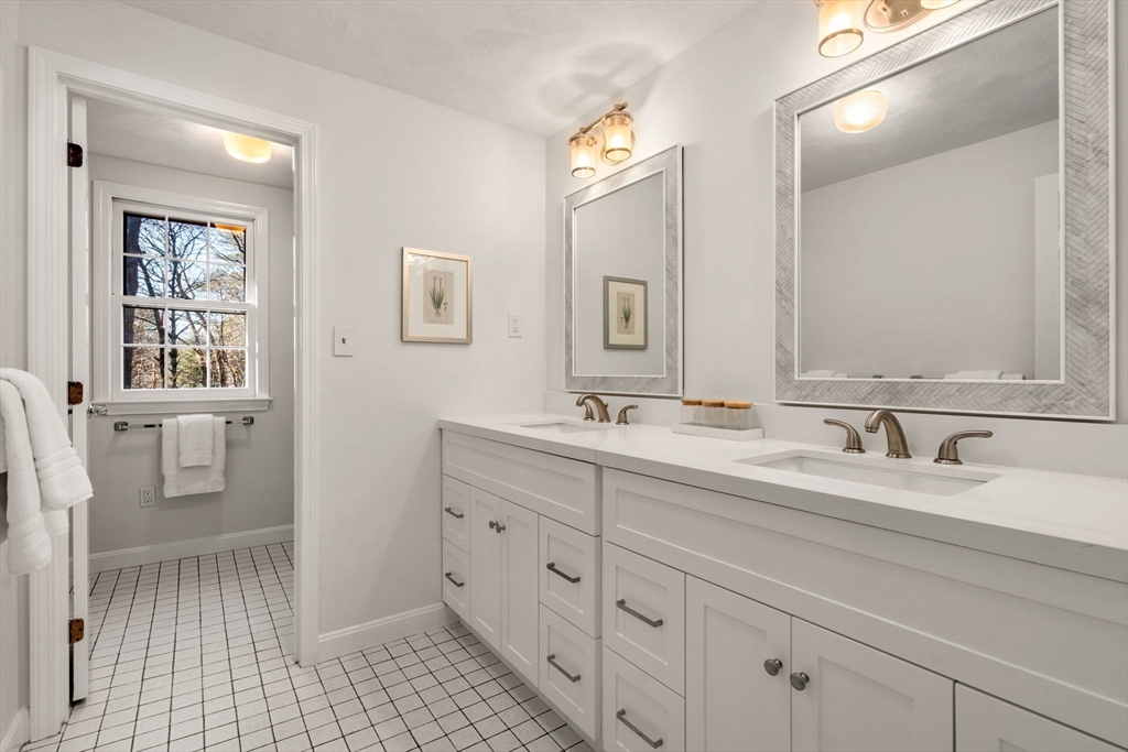 15 Bradyll Road Weston, MA 02493 - Photo 29 of 36 a bathroom with double vanity sink a mirror and a toilet