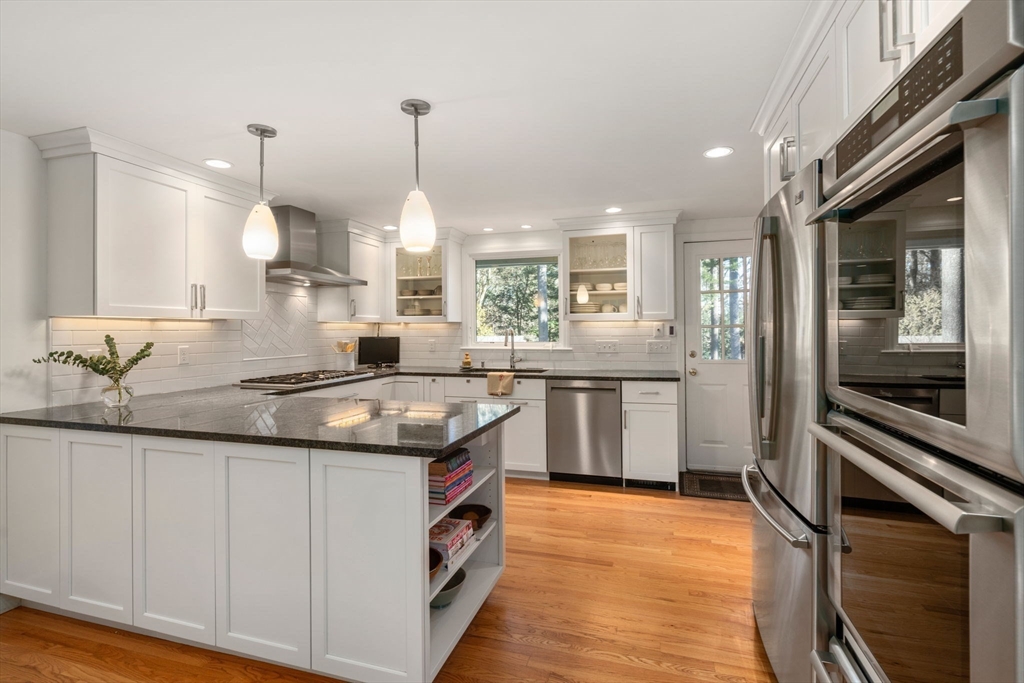 15 Bradyll Road Weston, MA 02493 - Photo 5 of 36 a kitchen with stainless steel appliances granite countertop a sink a stove and a refrigerator