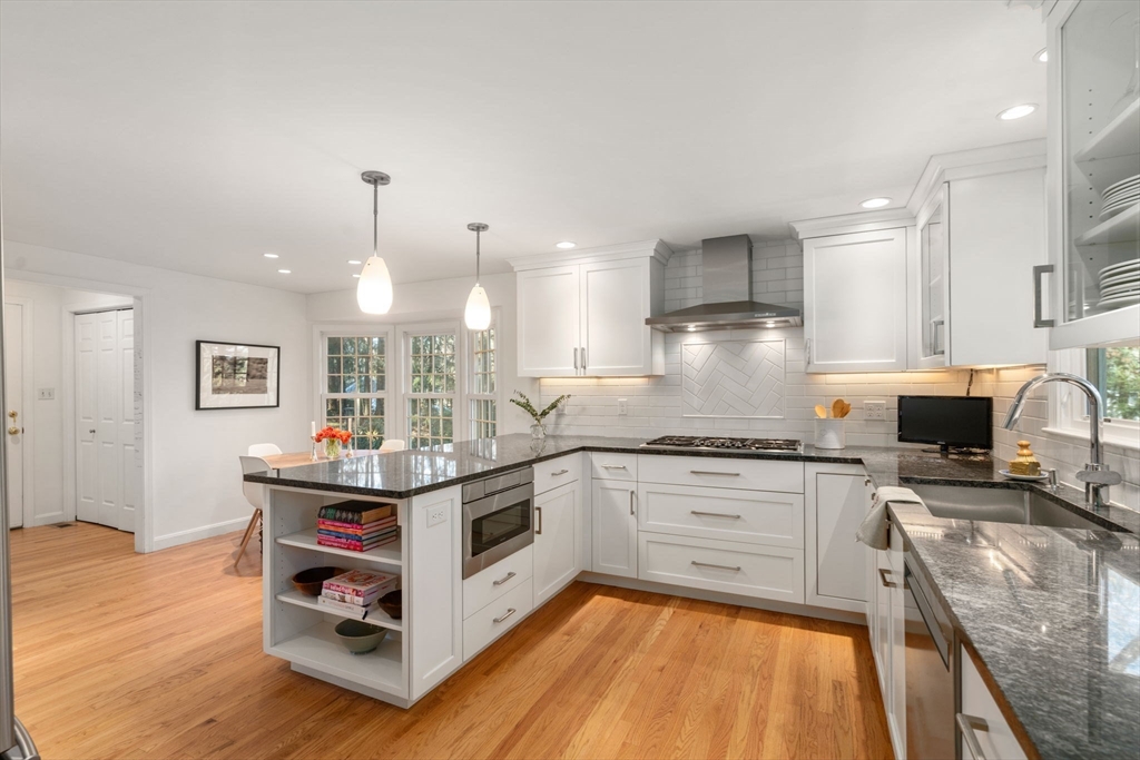 15 Bradyll Road Weston, MA 02493 - Photo 6 of 36 a kitchen with stainless steel appliances granite countertop a stove top oven a sink and a refrigerator