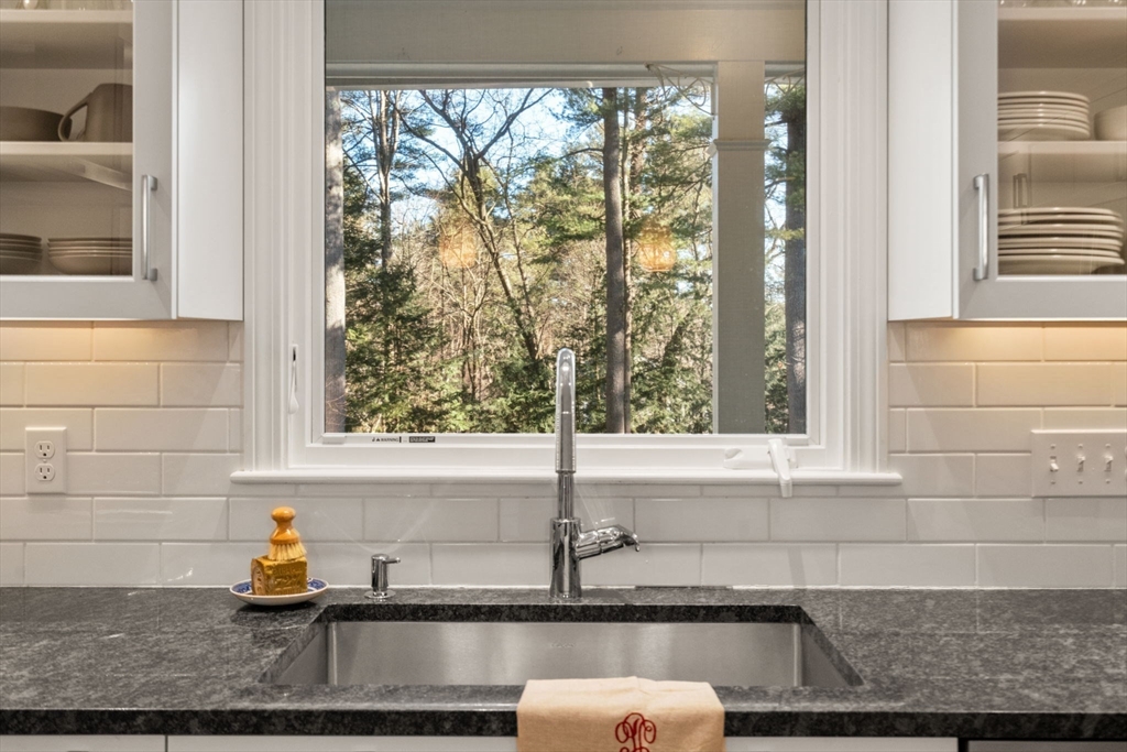 15 Bradyll Road Weston, MA 02493 - Photo 7 of 36 a bathroom with a granite countertop sink and a window