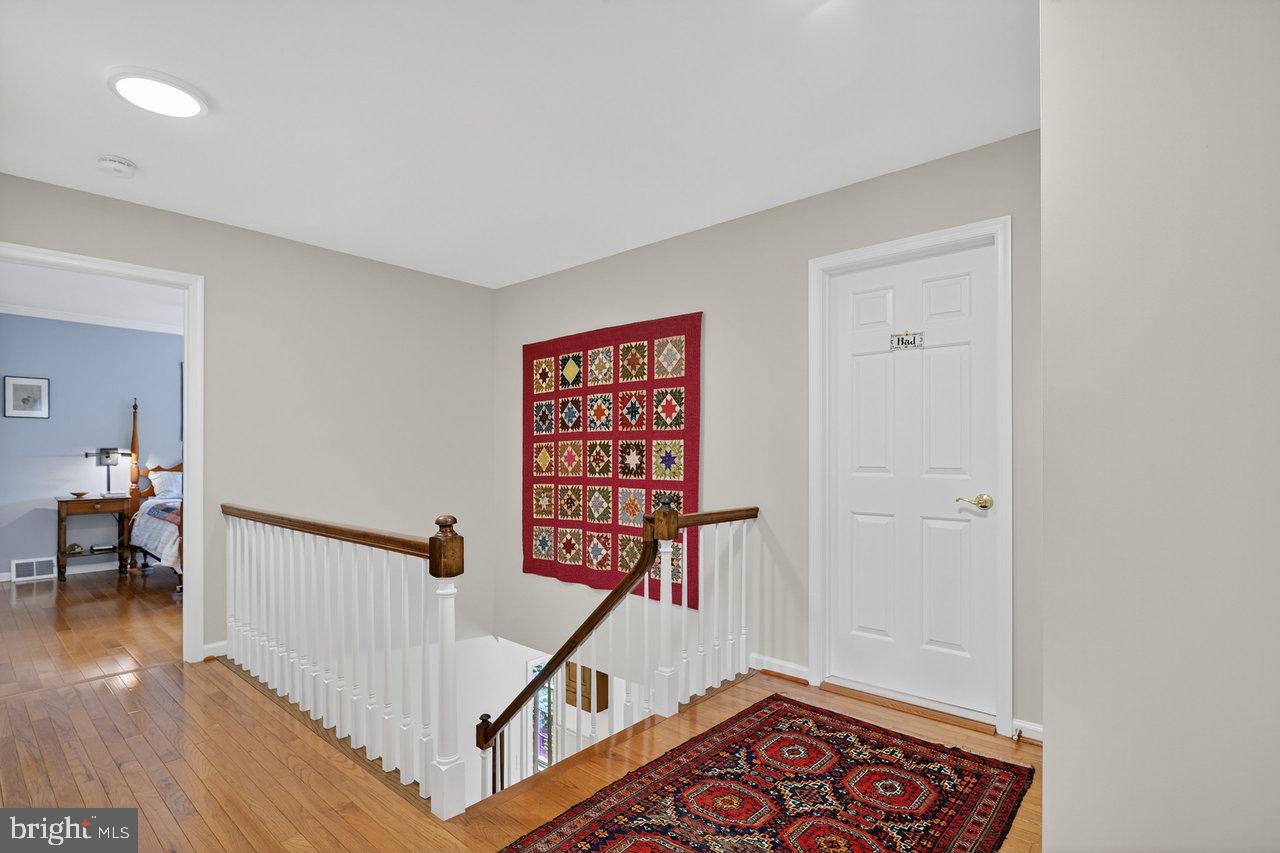 4 Locke Court Ewing, NJ 08628 - Photo 24 of 43 a view of a hallway with wooden floor and stairs