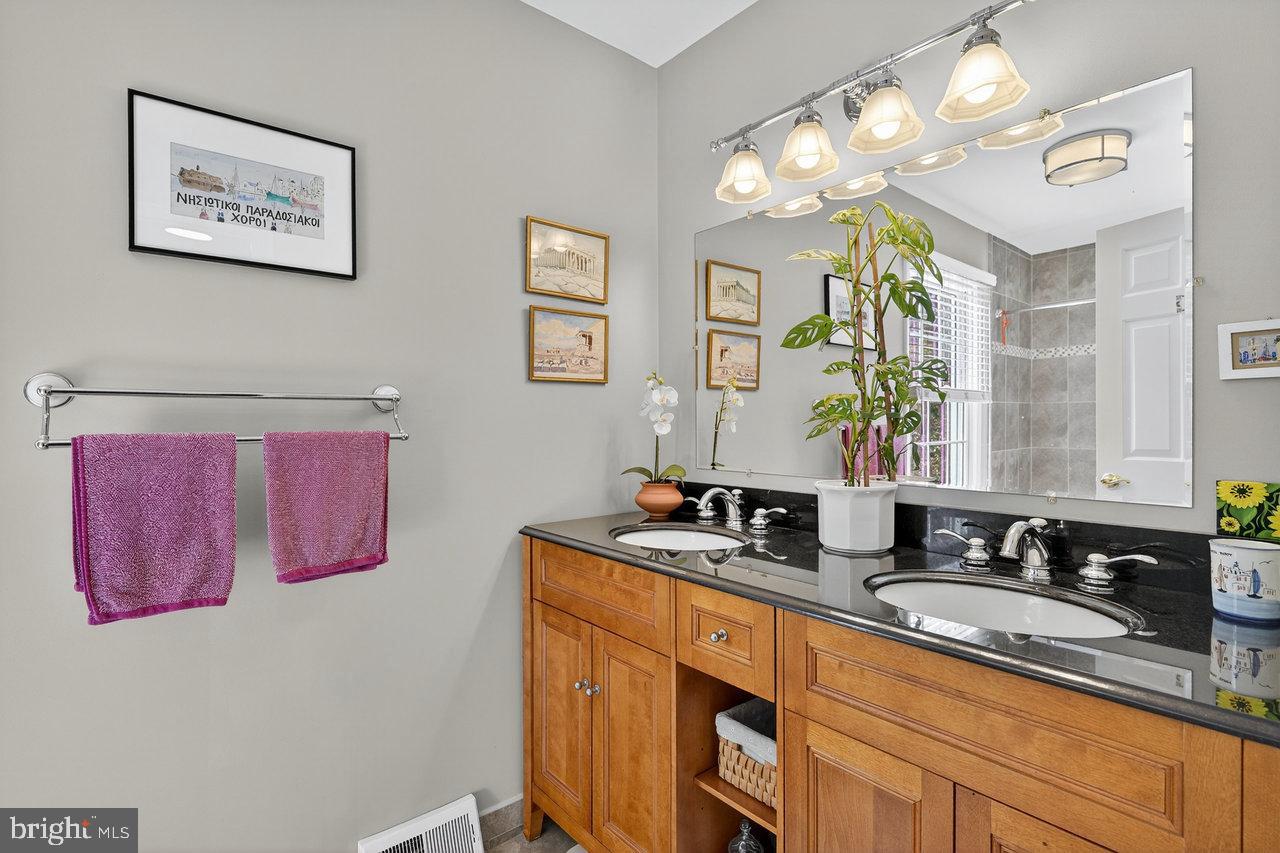 4 Locke Court Ewing, NJ 08628 - Photo 33 of 43 a bathroom with a double vanity sink and a mirror