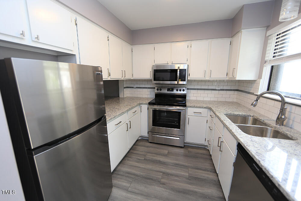 3775 Guess Road, Unit 22 Durham, NC 27705 - Photo 2 of 17 a kitchen with stainless steel appliances a refrigerator sink and microwave