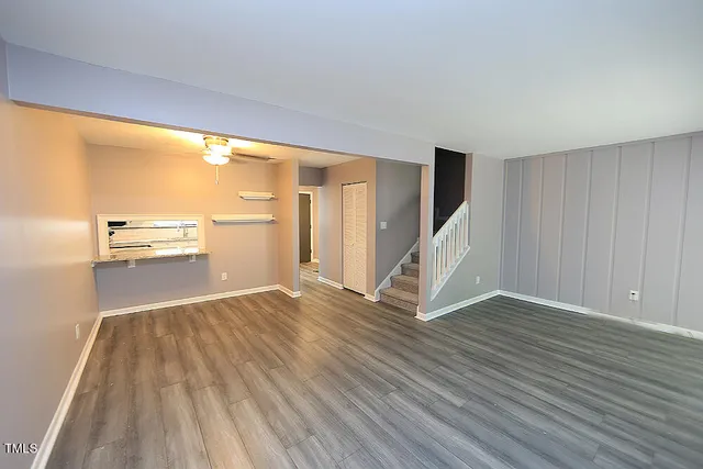 wooden floor in an empty room with a window