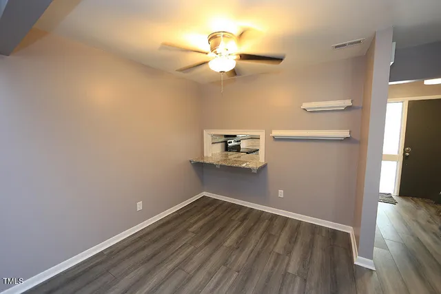 a view of a room with wooden floor