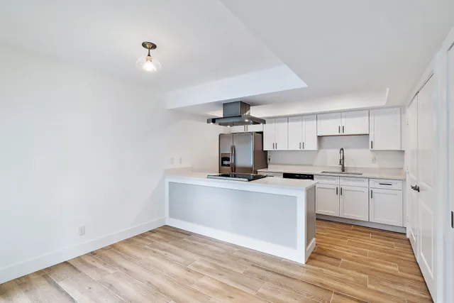 a kitchen with stainless steel appliances a sink stove and cabinets