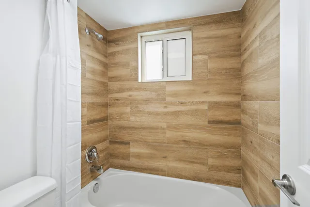 a bathroom with a toilet and a shower