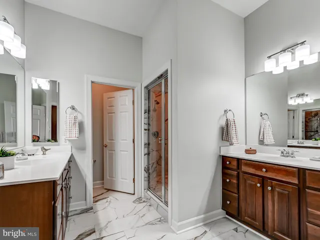 a bathroom with a double vanity sink mirror and toilet