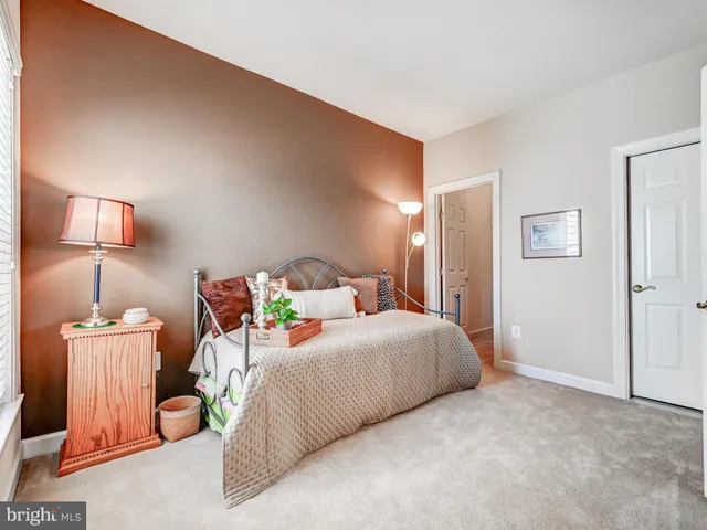 a view of a kitchen with kitchen island a sink a stove and a refrigerator with wooden floor